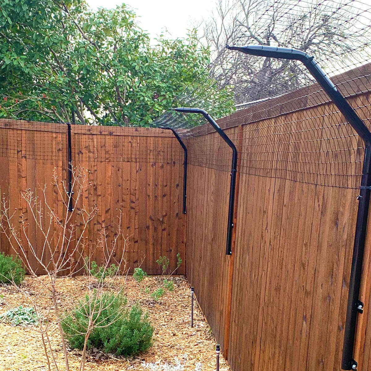 Curved dog arm extension to prevent jumping over pet fences by Dog Proofer.