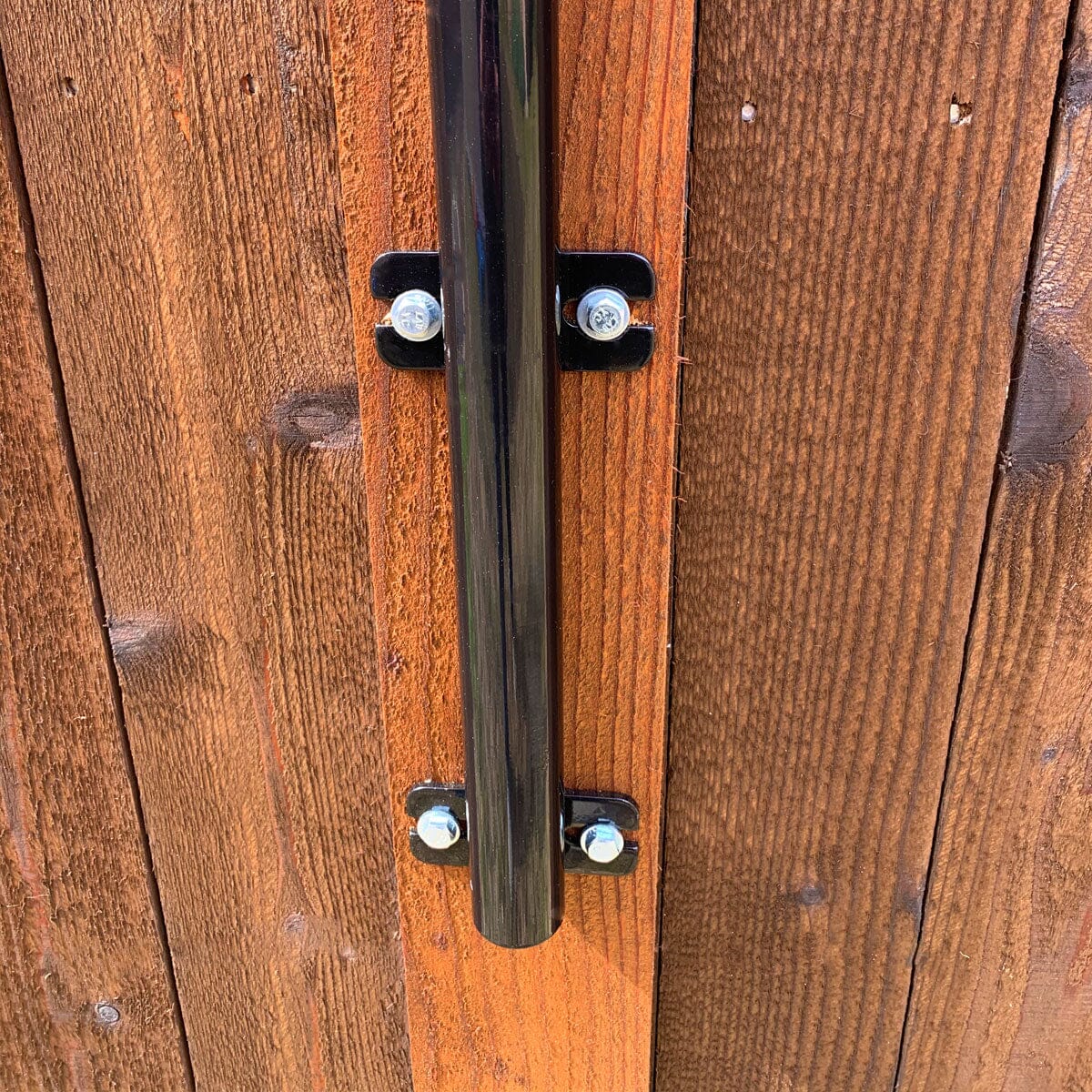 Close-up of the holding bracket for dog fences by Dog Proofer, emphasizes the sturdy construction and finish.
