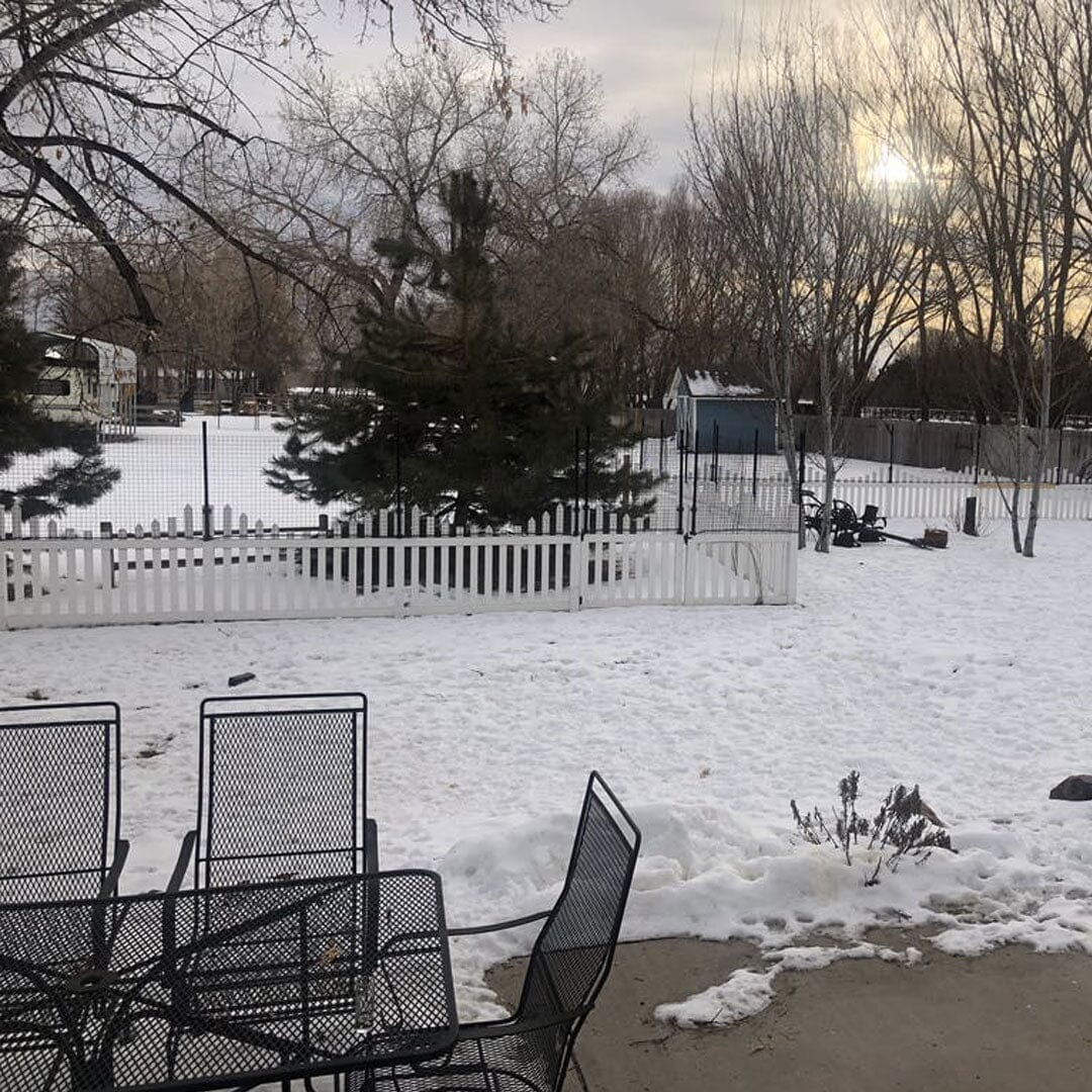 Dog Fence Height Extension Kit Installed on Wood Picket Fence by Dog Proofer